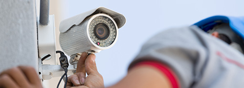 Electronic Security Camera Being Installed